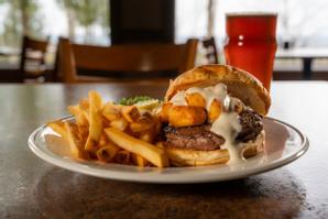 The Landmark Resort | Egg Harbor | The mouthwatering Wisconsin Burger is topped with flash-fried Renard's Artisan Cheese Curds, creamy ranch dressing, lettuce, tomato, and sliced onion