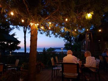 Evening dining under string lights on the terrace at Ember Restaurant in Egg Harbor