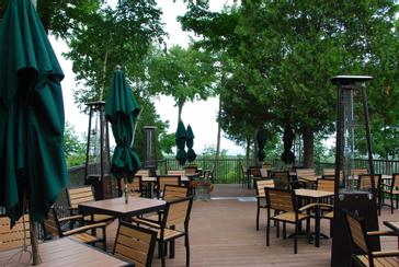 Outdoor tables, umbrellas and patio heaters on the Ember Restaurant terrace in Egg Harbor