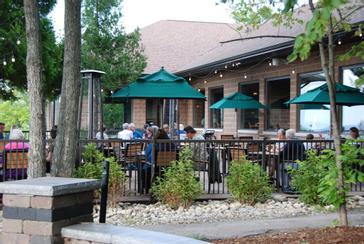 Guests dining on the outdoor patio at Ember Restaurant in Egg Harbor