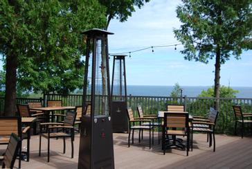 Patio heater and tables on the bay-view terrace at Ember Restaurant in Egg Harbor