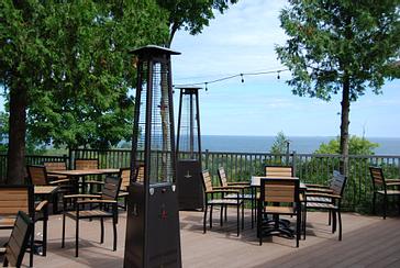Patio heater and tables on the bay-view terrace at Ember Restaurant in Egg Harbor