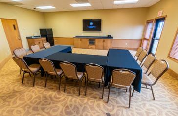 The Spinnaker Room features a large flat-screen TV and small kitchenette